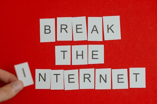 Cutout letters forming 'Break the Internet' on a vibrant red background.